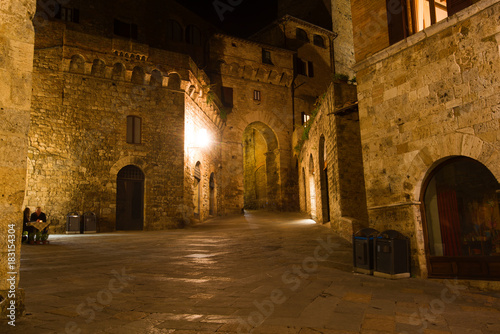 Night on the city square of medieval Gimignano. Tuscany, Italy