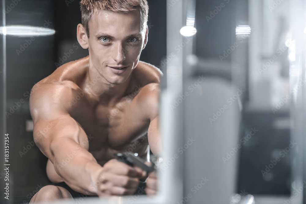 Handsome model young man training back in gym Handsome model young man training back in gym