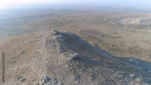Wallpaper Mural Aerovideo high above of beauty autumn cliff ridge in Armenia. Successful stylish man in colorful coat quick motion run on the rock trail, feel happiness and independence loneless with no people around Torontodigital.ca