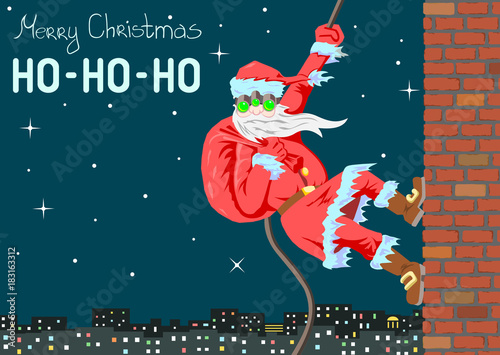 Santa Claus climbs the wall in a night vision device Santa with face. Picture has the proportions and dimensions of an international postcard. Santa descends on a rope along the wall of the house.