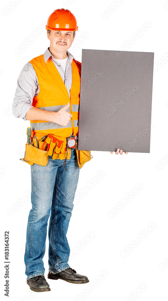 male builder or manual worker in helmet with white blank banner over white wall background. male builder or manual worker in helmet with white blank banner over white wall background.