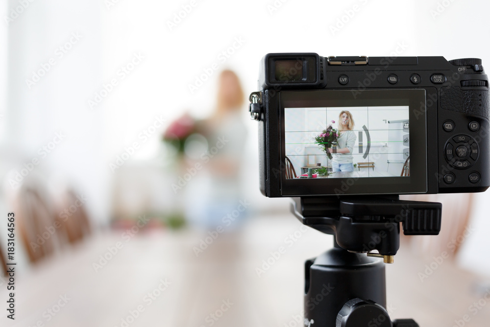 Defocused image of florist woman recording to camera master class