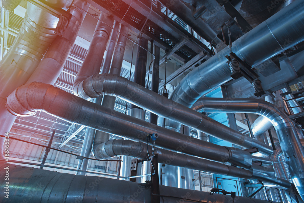 Equipment, cables and piping as found inside of a modern industrial power plant Equipment, cables and piping as found inside of a modern industrial power plant