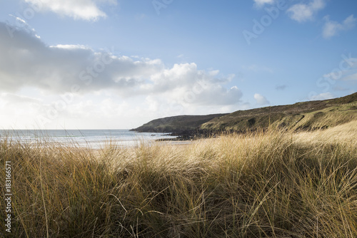 Beautiful landscape image of Freshwater West beach with sand dunes on Pembrokeshire Coast in Wales