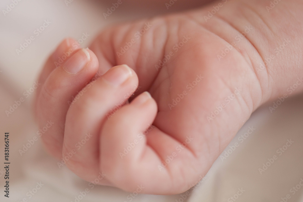 Hand the sleeping baby in the hand of mother close-up. Hand the sleeping baby in the hand of mother close-up.