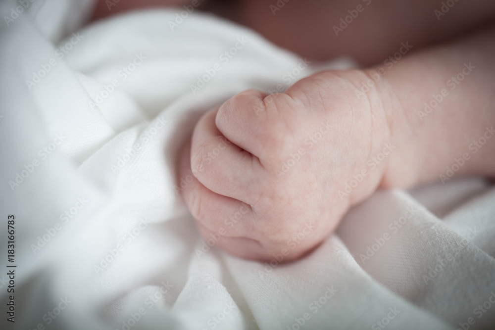 Hand the sleeping baby in the hand of mother close-up. Hand the sleeping baby in the hand of mother close-up.