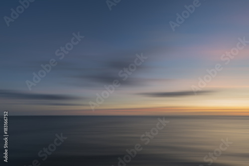 Stunning long exposure landscape image of calm sea at St Govan's Head on Pembrokeshire Coast in Wales