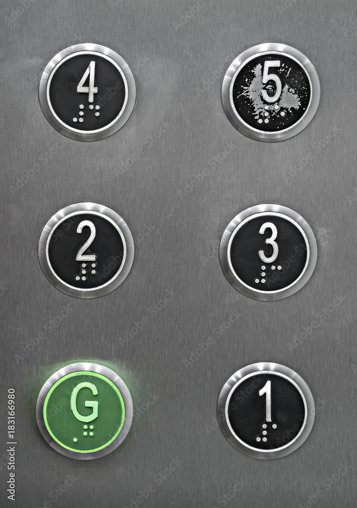Generic series of metal elevator buttons shot straight on. Generic series of metal elevator buttons shot straight on.