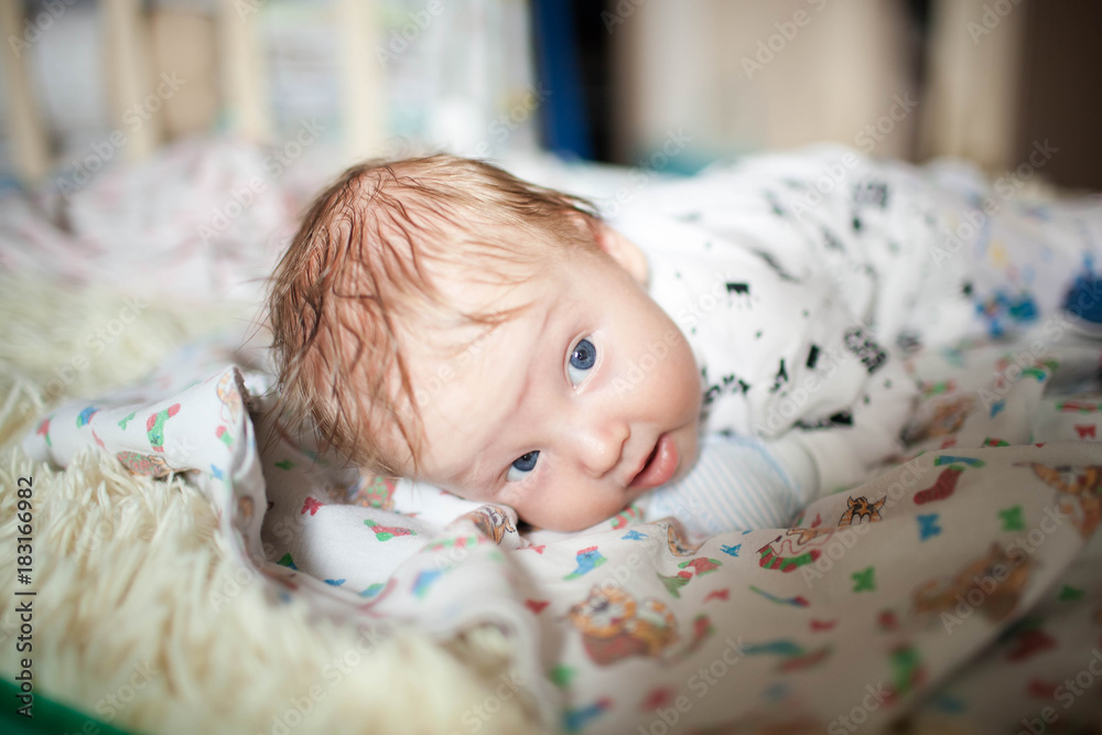 A newborn lies on his stomach and learn to keep your head A newborn lies on his stomach and learn to keep your head