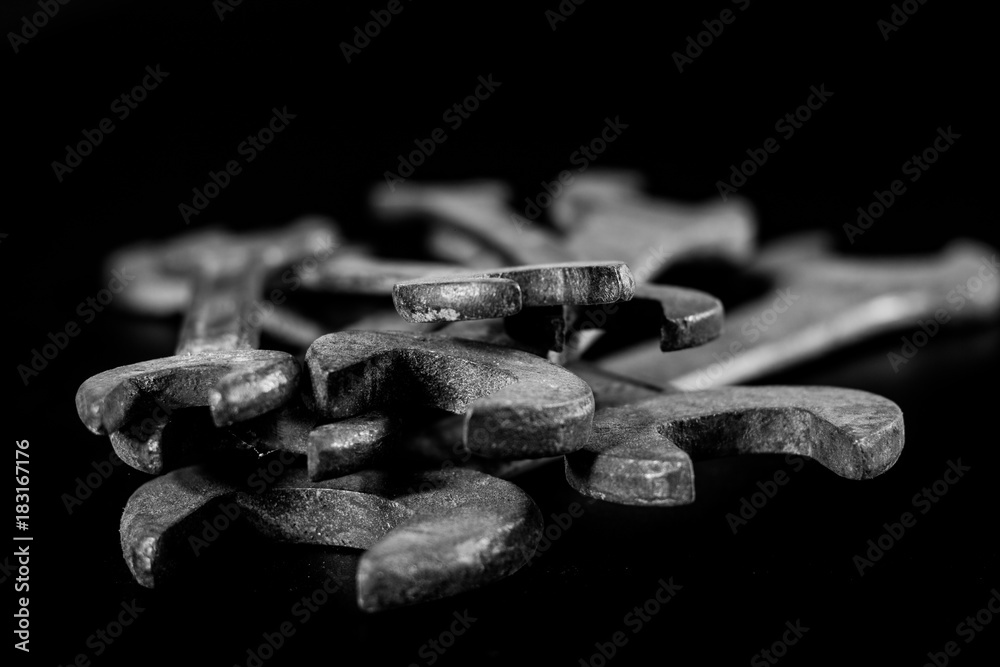 Rusty, old workshop keys. Hydraulic keys on a black table in a workshop. Black background. Rusty, old workshop keys. Hydraulic keys on a black table in a workshop. Black background.