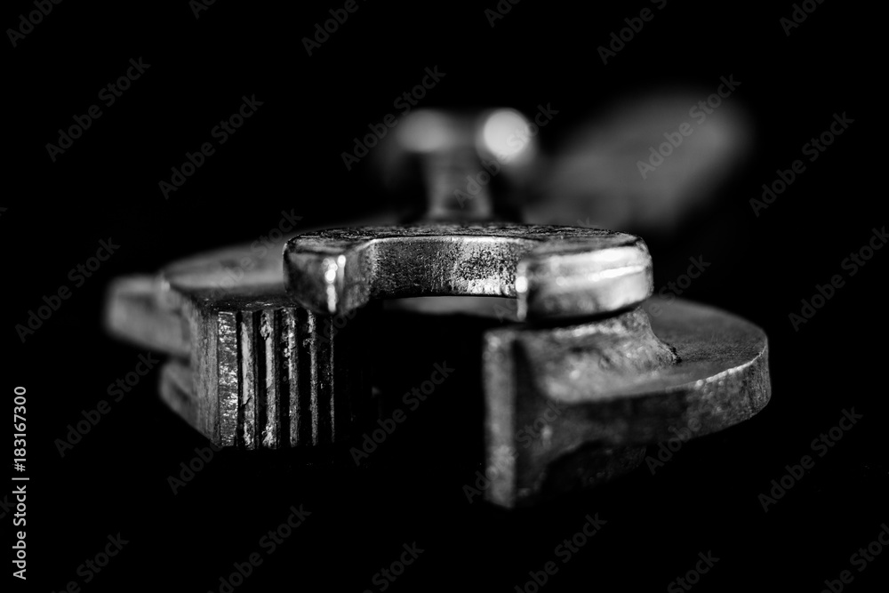 Rusty, old workshop keys. Hydraulic keys on a black table in a workshop. Black background. Rusty, old workshop keys. Hydraulic keys on a black table in a workshop. Black background.