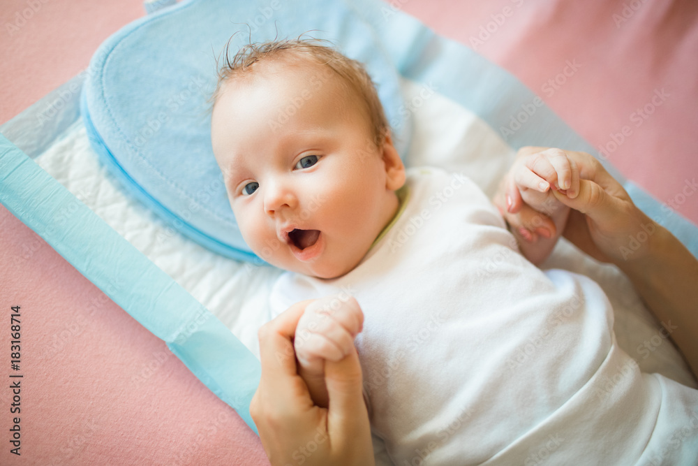 Newborn baby lying on the diaper and is happy Newborn baby lying on the diaper and is happy