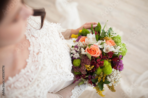beautiful wedding bouquet with roses in bride's hands.