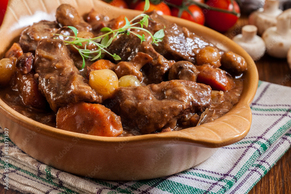 Beef Bourguignon stew served with baguette Beef Bourguignon stew served with baguette