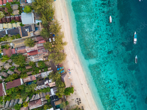 An aerial view of Gili Trawangan Island coastline with boats and buildings, West Nusa Tenggara, Indonesia