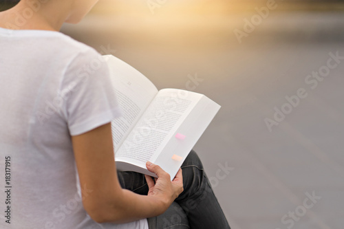 Young woman reading a book at house