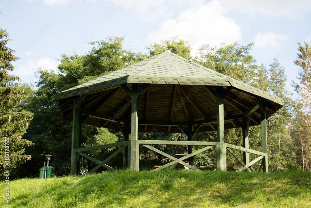 Leisure gazebo in the forest and garden. Season of autumn.