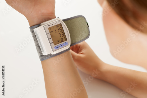 a blood pressure measuring device on a woman's hand