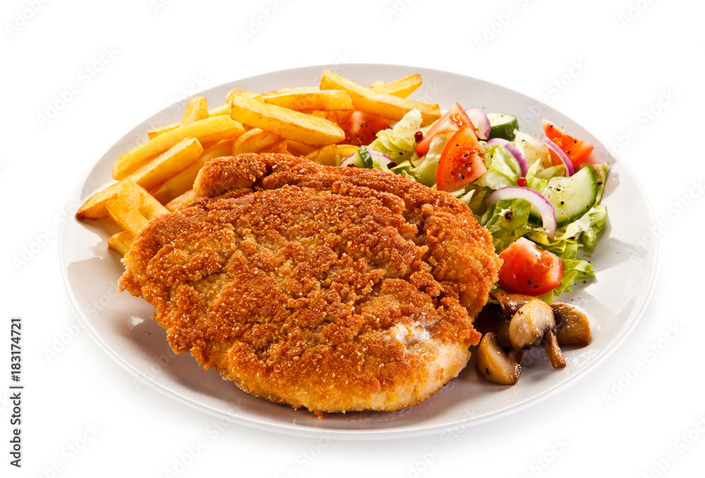 Fried pork chop, French fries and vegetables Fried pork chop, French fries and vegetables