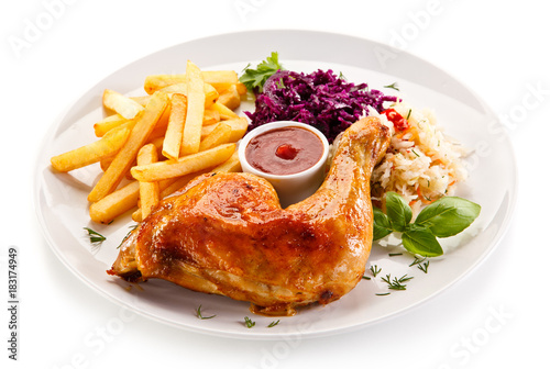     Roast chicken legs with chips and vegetables  photo