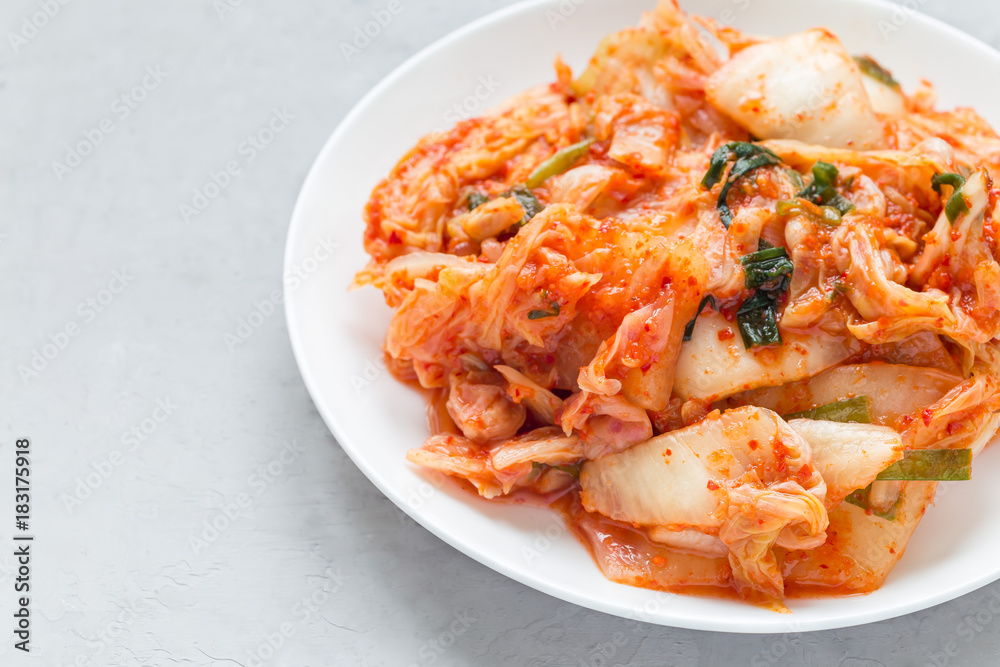 Kimchi cabbage. Korean appetizer on white plate, horizontal, copy space Kimchi cabbage. Korean appetizer on white plate, horizontal, copy space