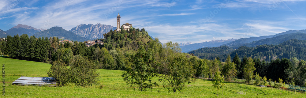 Castle on the hill landscape, mountains and peaks in background. Trentino South Tirol Castello Molina Di Fiemme, Alto Adige, Italy - Saint George Church