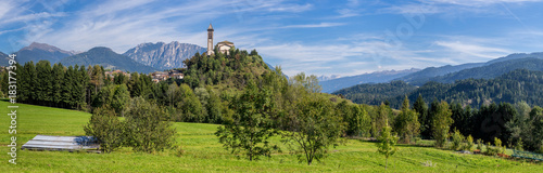 Castle on the hill landscape, mountains and peaks in background. Trentino South Tirol Castello Molina Di Fiemme, Alto Adige, Italy - Saint George Church photo