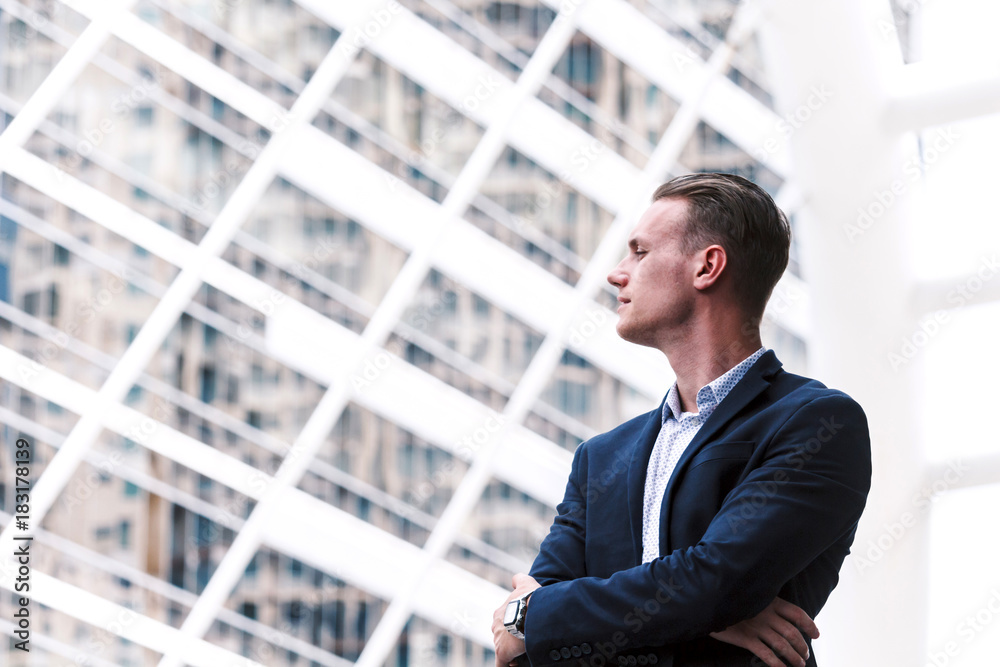 Portrait of handsome man in black suit standing outdoors Portrait of handsome man in black suit standing outdoors