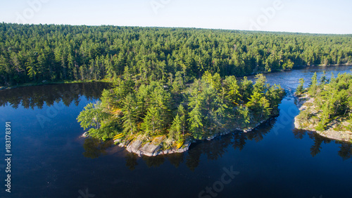 Aerial view of camping on the edge of a river during a family canoe trip