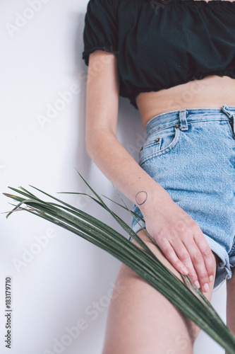 girl with minimalist tattoo detailed on white background