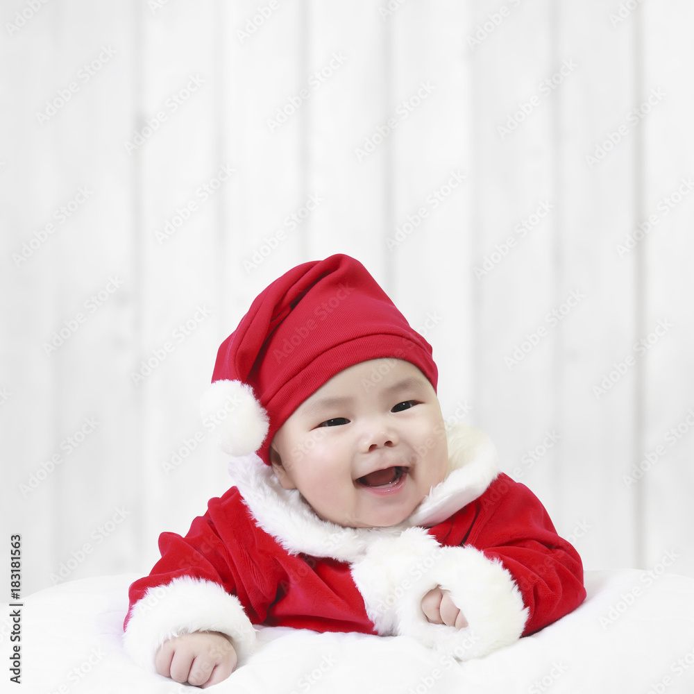 asian children cute or kid and baby wearing santa claus suit with fun or happy and smile in the winter on white wood wall background for christmas or xmas and happy new year with space asian children cute or kid and baby wearing santa claus suit with fun or happy and smile in the winter on white wood wall background for christmas or xmas and happy new year with space