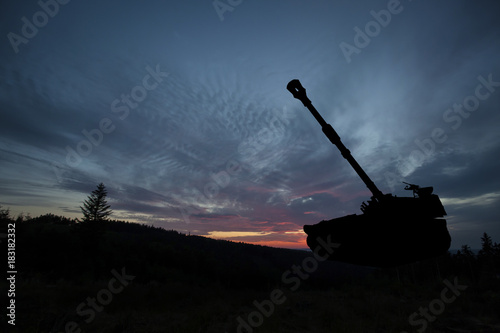 Photography War Concept. Military tank silhouette scene on sky background