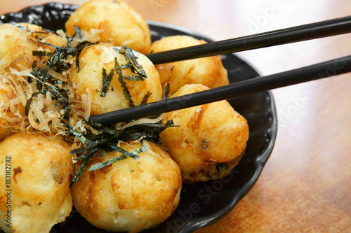 Photography delicious takoyaki squid ball for snack or dessert with chopsticks at lunch or d