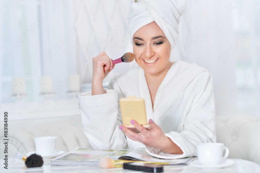 Woman applying make up 