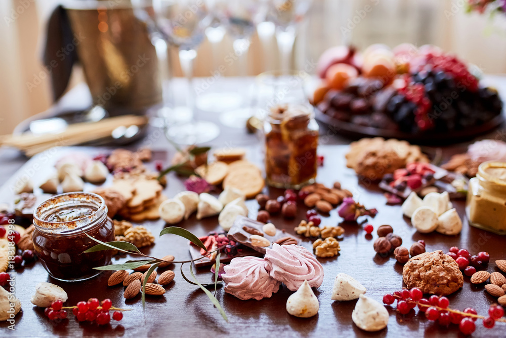 Fototapeta premium Delicious sweets on candy buffet. different sweets on a wooden table