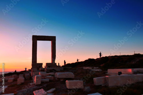 Portara ruins entrance of ancient temple of Apollo at sunset on Naxos island, Greece photo