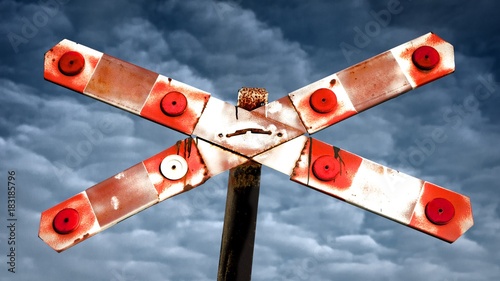 Ralway crossing label sign with cloudy sky