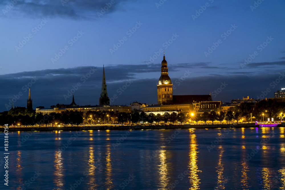 View of the embankment of the river Daugava and the old town in Riga at sunset. View of the embankment of the river Daugava and the old town in Riga at sunset.