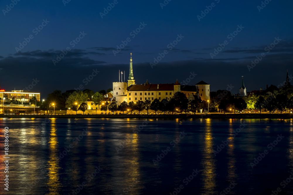 View of the embankment of the river Daugava and the old town in Riga at sunset.