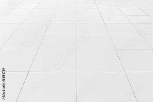 White tile floor background in perspective view. Clean, shiny, symmetry with grid line texture. For decoration in bathroom, kitchen and laundry room. And empty or copy space for product display also.