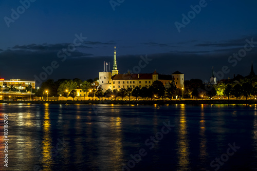 View of the embankment of the river Daugava and the old town in Riga at sunset.