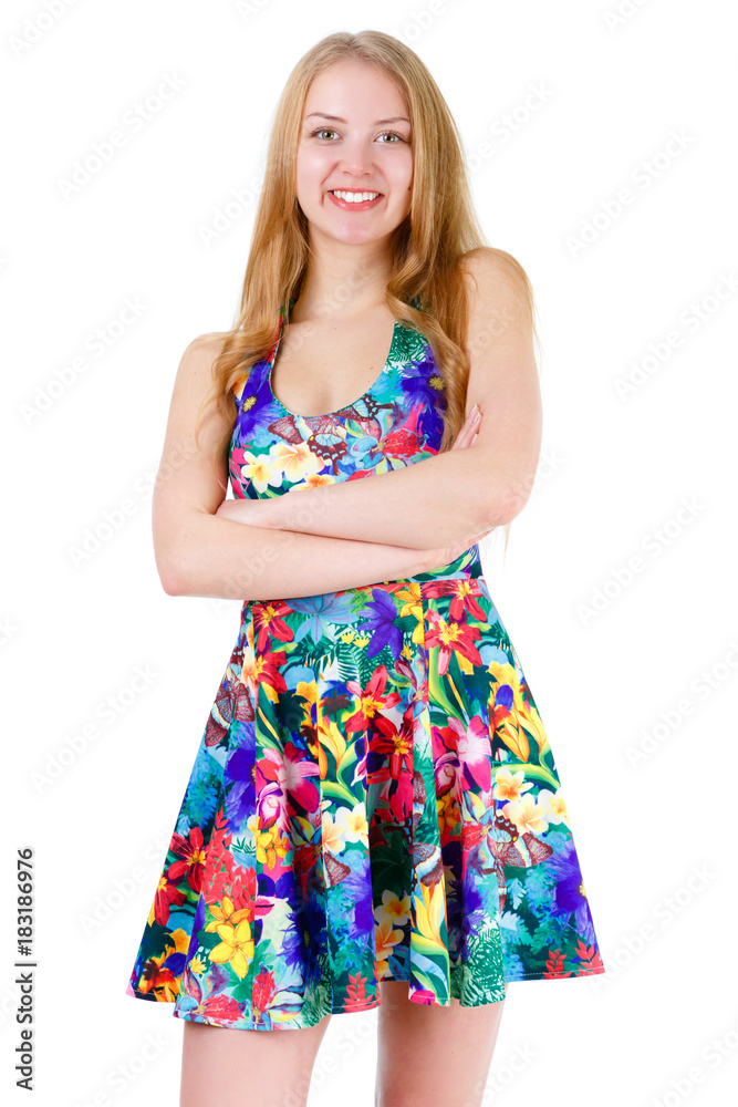 Portrait of young cute smile girl stands with crossed hands in mix color summer dress posing isolated on white background, positive human emotion, facial expression Portrait of young cute smile girl stands with crossed hands in mix color summer dress posing isolated on white background, positive human emotion, facial expression
