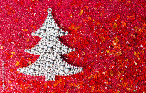 Silver Christmas tree on red background photo