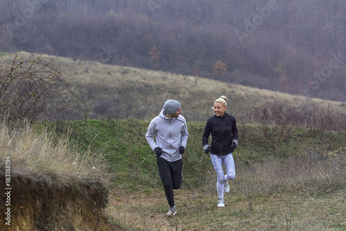Young couple jogging in nature at cold day © pucko_ns