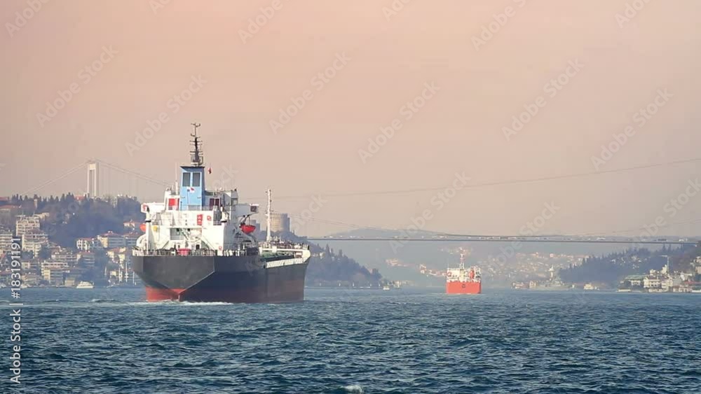 Cargo vessels cruising along Bosphorus Sea at sunset. Istanbul, Turkey Cargo vessels cruising along Bosphorus Sea at sunset. Istanbul, Turkey
