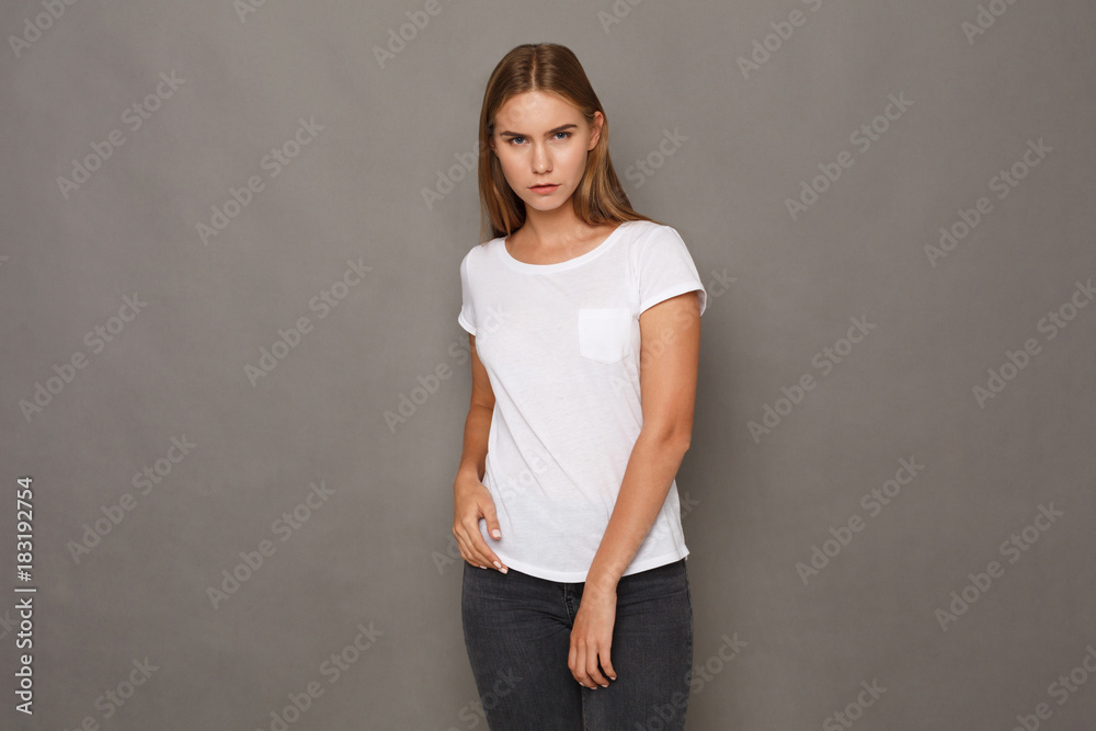Cheerful girl in casual clothes posing at studio Cheerful girl in casual clothes posing at studio
