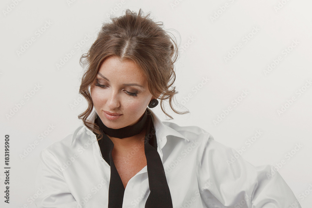 Young woman, beautiful hair, makeup, men's white shirt on a white background Young woman, beautiful hair, makeup, men's white shirt on a white background