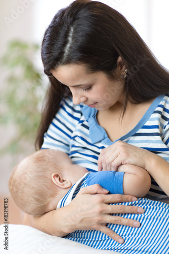 young mother breast feeding...
