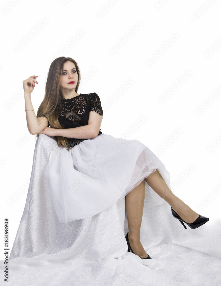 Naklejka premium Girl in white skirt posing sitting .