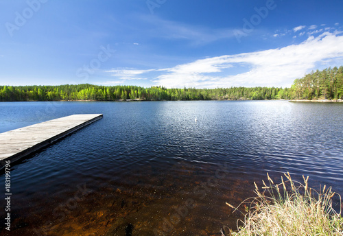 Wooden pier on beautiful lake in the national park Repovesi, Finland, South Karelia.